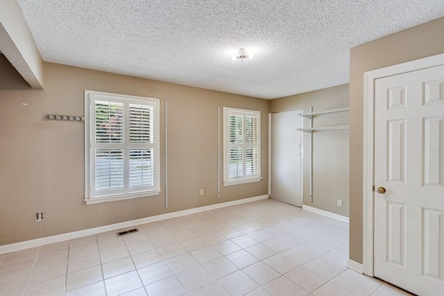 3464 Maynard Cir, Gainesville, GA 30506 - unfurnished bedroom with a textured ceiling and light tile patterned floors