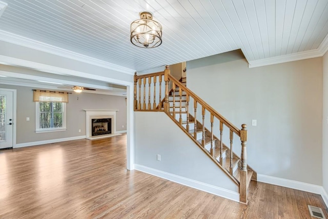 3464 Maynard Cir, Gainesville, GA 30506 - staircase with crown molding, wood finished floors, a chandelier, a fireplace with raised hearth, and wooden ceiling