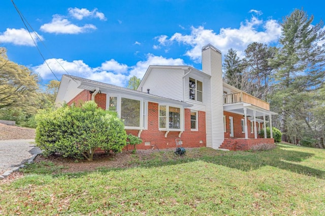 3464 Maynard Cir, Gainesville, GA 30506 - view of property exterior featuring brick siding, a chimney, a yard, a balcony, and covered porch