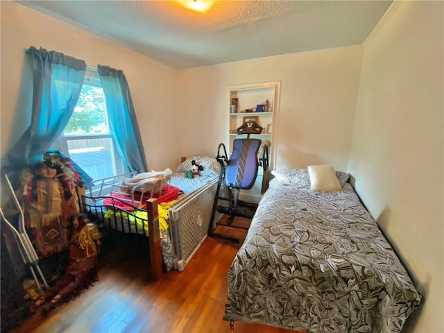 bedroom featuring dark wood-type flooring and a textured ceiling