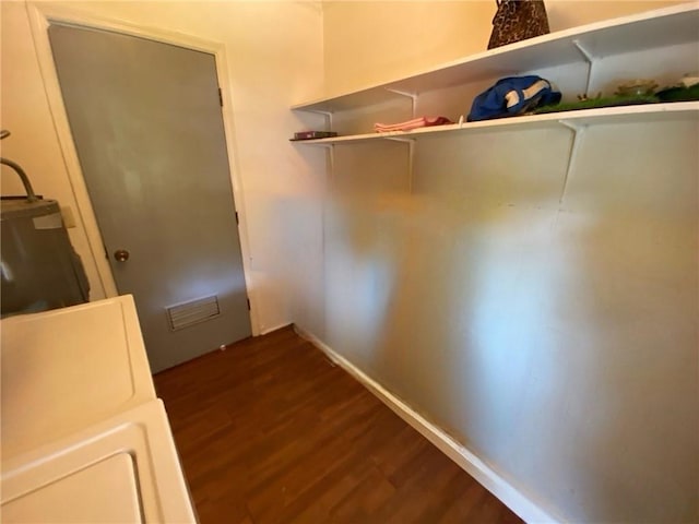 interior space with water heater and dark wood-type flooring