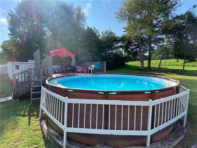 view of pool with a lawn