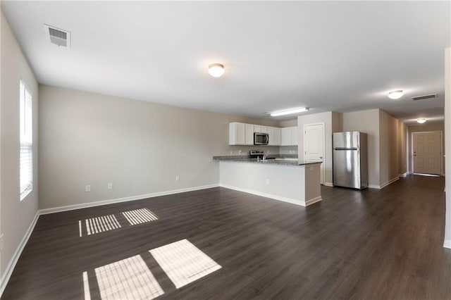 64 Middleton Ct, Chatsworth, GA 30705 - unfurnished living room with baseboards and dark wood-style floors