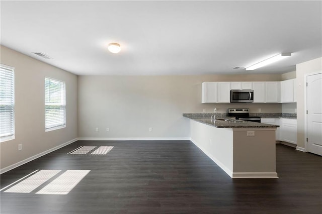 64 Middleton Ct, Chatsworth, GA 30705 - kitchen with stainless steel appliances, white cabinetry, a peninsula, and dark wood finished floors