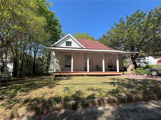 1090 Forest Ave, Stone Mountain, GA 30083 - country-style home with a porch, a front lawn, and a chimney