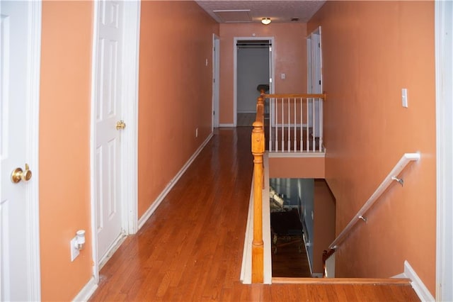 corridor with hardwood / wood-style floors