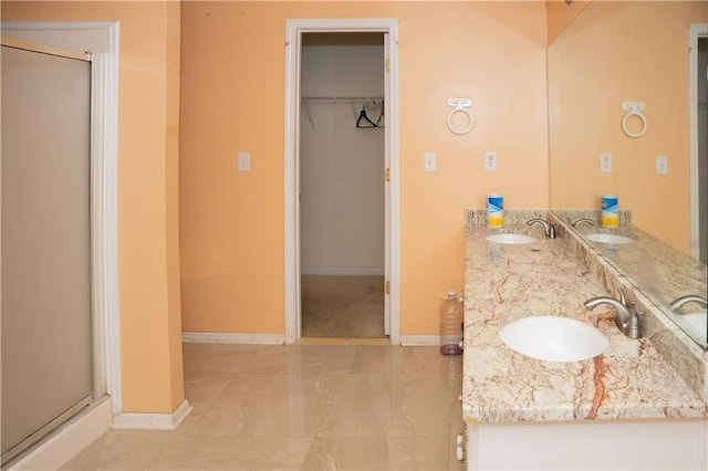 bathroom featuring vanity and an enclosed shower