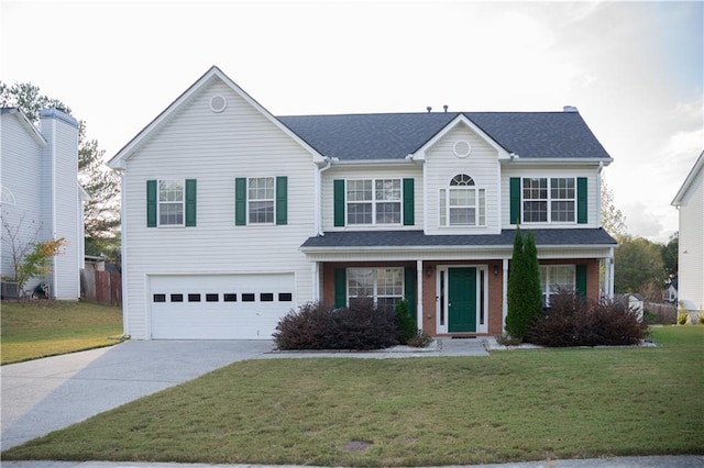 front facade featuring a front yard and a garage