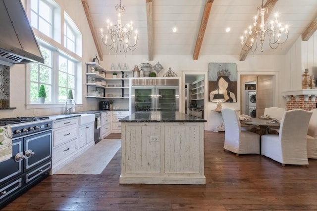 kitchen with pendant lighting, a center island, stainless steel appliances, and range hood