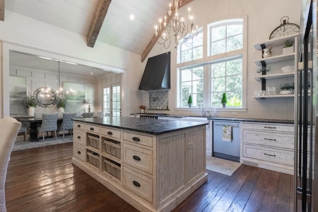 kitchen featuring a center island, backsplash, ventilation hood, stainless steel dishwasher, and decorative light fixtures