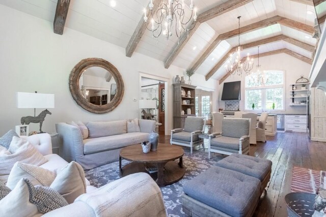 living room featuring dark hardwood / wood-style flooring, lofted ceiling with beams, and an inviting chandelier