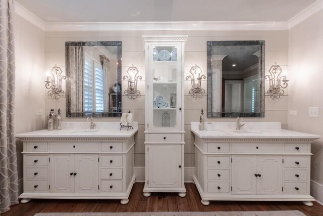 bathroom with hardwood / wood-style floors, vanity, and ornamental molding