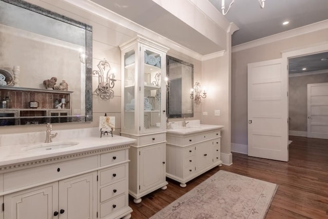 bathroom featuring hardwood / wood-style floors, vanity, and crown molding