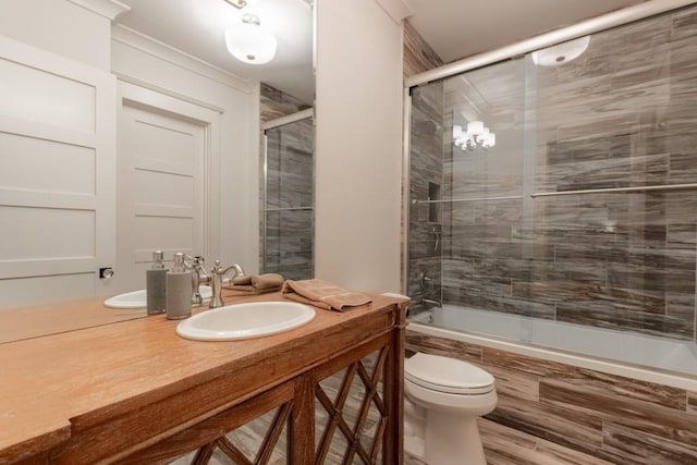 full bathroom with vanity, toilet, and shower / bath combination with glass door