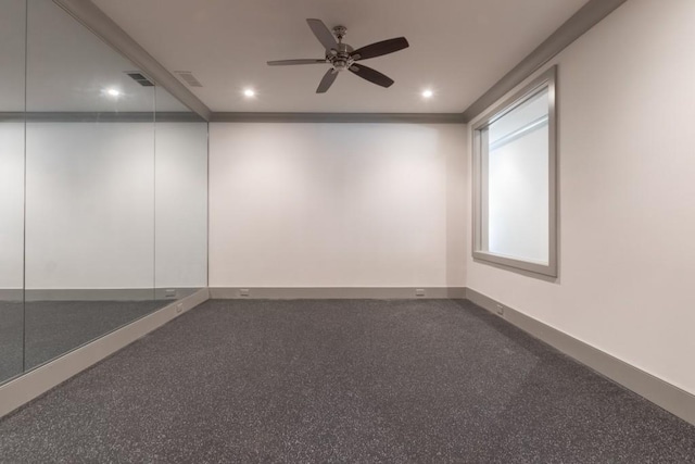 empty room with dark colored carpet and ceiling fan