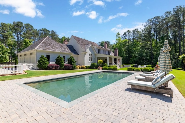 view of pool with a yard and a patio