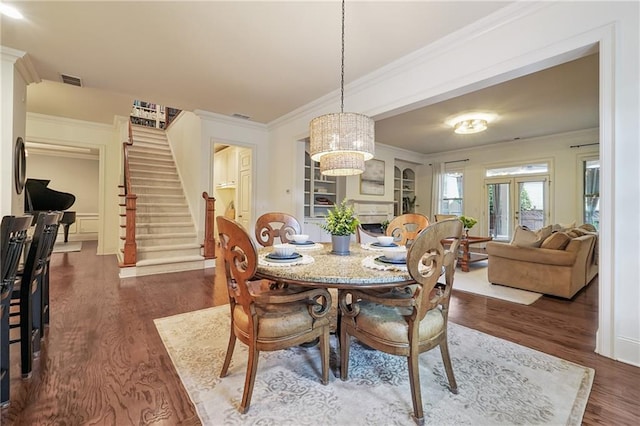 715 Saybeck Way, Milton, GA 30004 - dining space featuring dark wood finished floors, stairway, ornamental molding, and a chandelier