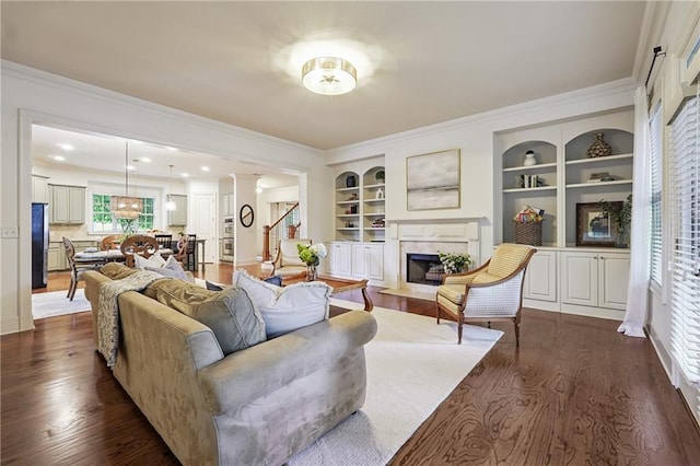 715 Saybeck Way, Milton, GA 30004 - living area with a premium fireplace, dark wood finished floors, crown molding, and built in shelves