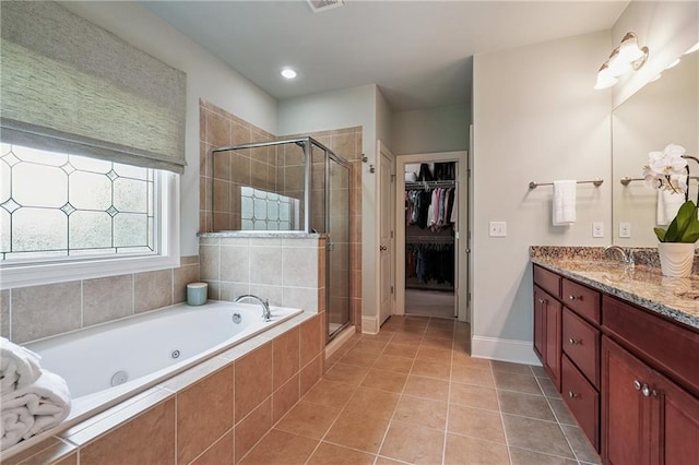 715 Saybeck Way, Milton, GA 30004 - bathroom with a tub with jets, a stall shower, double vanity, tile patterned flooring, and a spacious closet