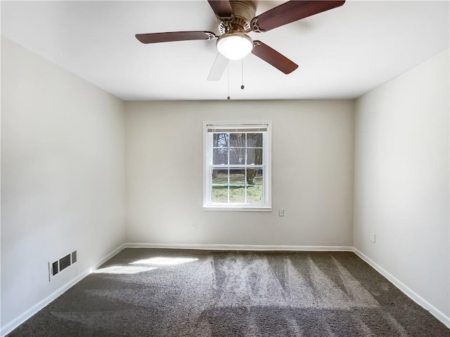 carpeted spare room featuring visible vents, ceiling fan, and baseboards