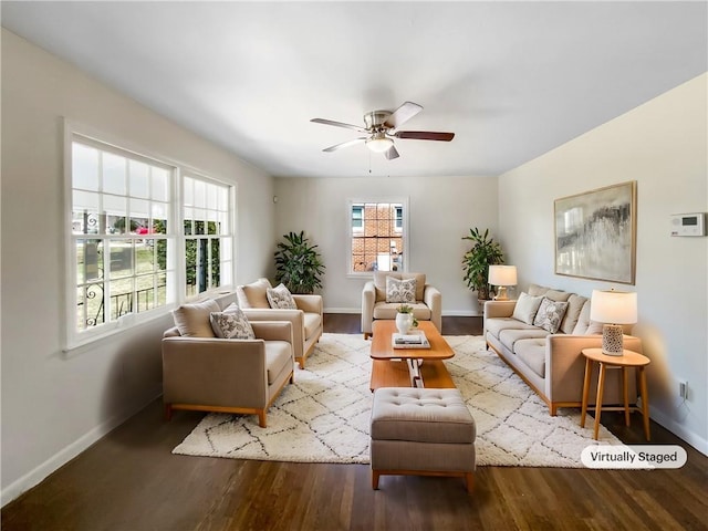 living area with wood finished floors, a ceiling fan, and baseboards