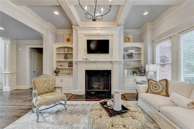 living room featuring a fireplace, dark hardwood / wood-style floors, a chandelier, and ornamental molding