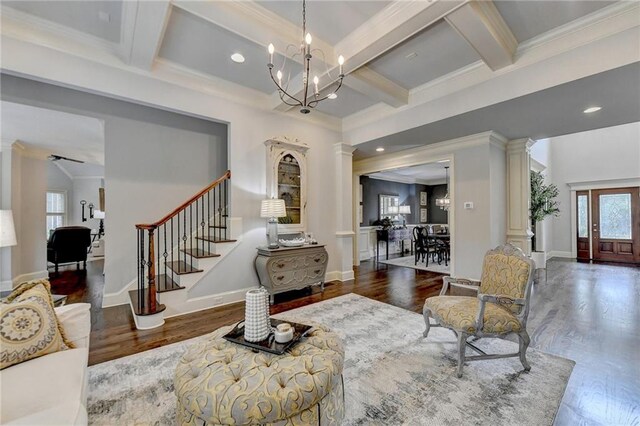 living room featuring beam ceiling, dark hardwood / wood-style floors, and plenty of natural light