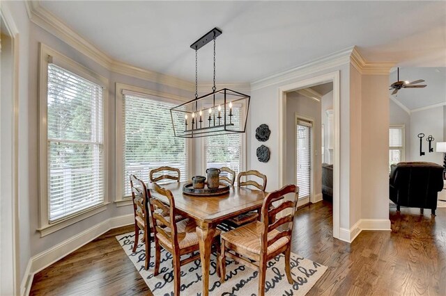 dining room featuring lofted ceiling, crown molding, dark hardwood / wood-style flooring, and ceiling fan with notable chandelier