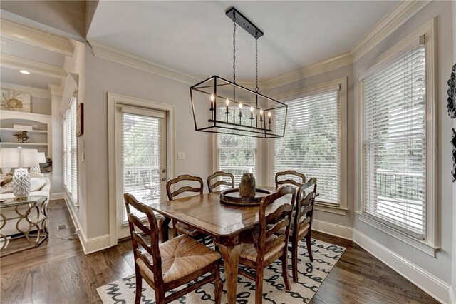 dining area with dark hardwood / wood-style floors, a healthy amount of sunlight, crown molding, and an inviting chandelier