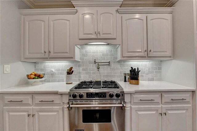 kitchen featuring high end stove and white cabinetry