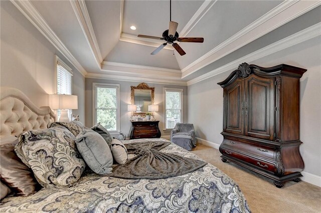 carpeted bedroom with a raised ceiling, ceiling fan, and ornamental molding