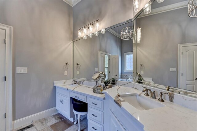 bathroom with a chandelier, vanity, and crown molding