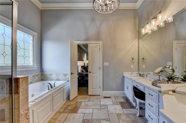 bathroom with vanity, crown molding, a tub, and a chandelier