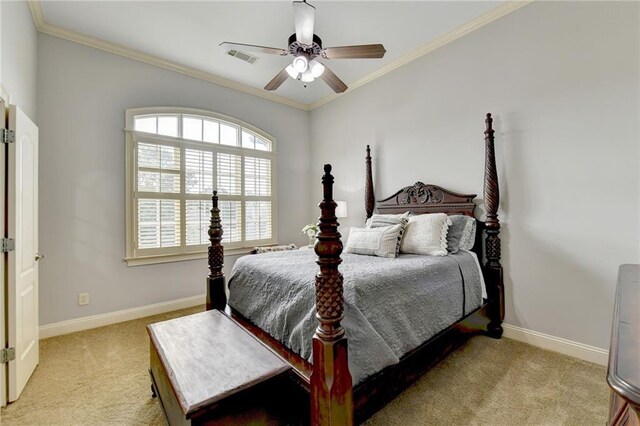 carpeted bedroom featuring ceiling fan and crown molding