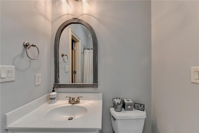 bathroom featuring vanity and toilet