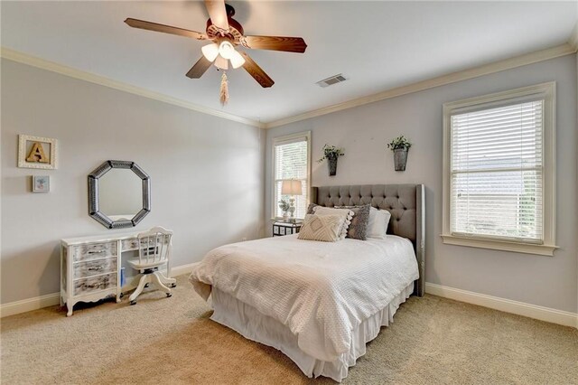 carpeted bedroom featuring ceiling fan and ornamental molding