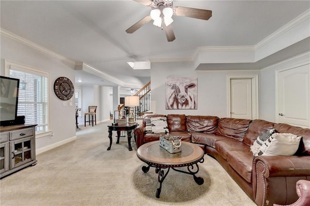 carpeted living room with ceiling fan and crown molding