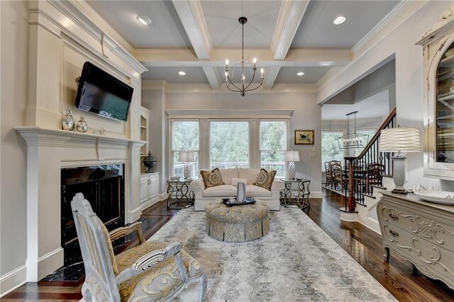 living room featuring beamed ceiling, ornamental molding, a fireplace, and coffered ceiling