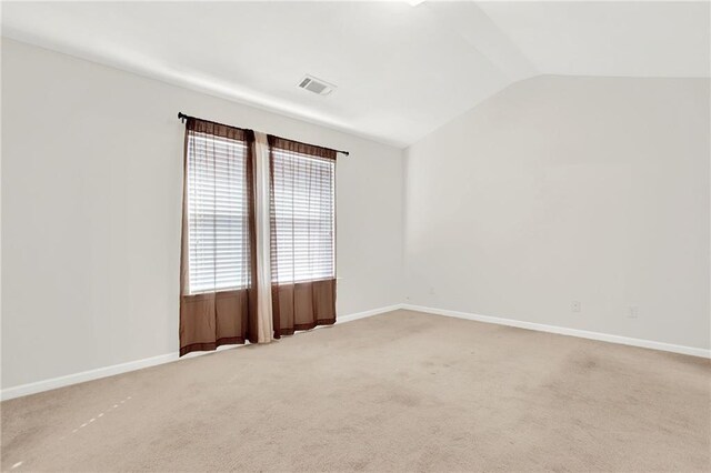 unfurnished room featuring lofted ceiling, carpet floors, and baseboards