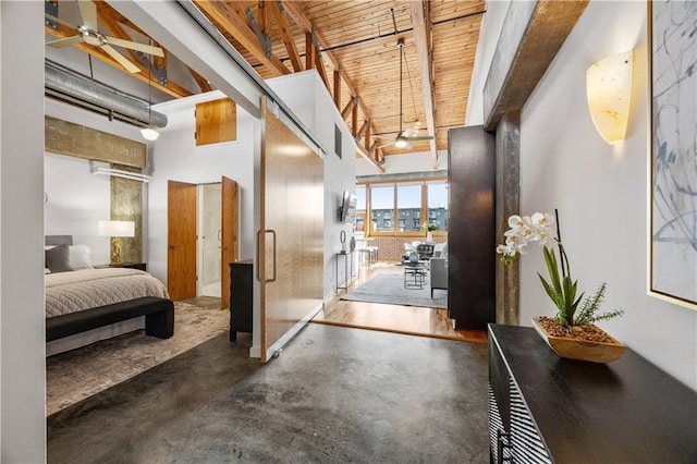 hallway featuring beamed ceiling, a towering ceiling, and wooden ceiling