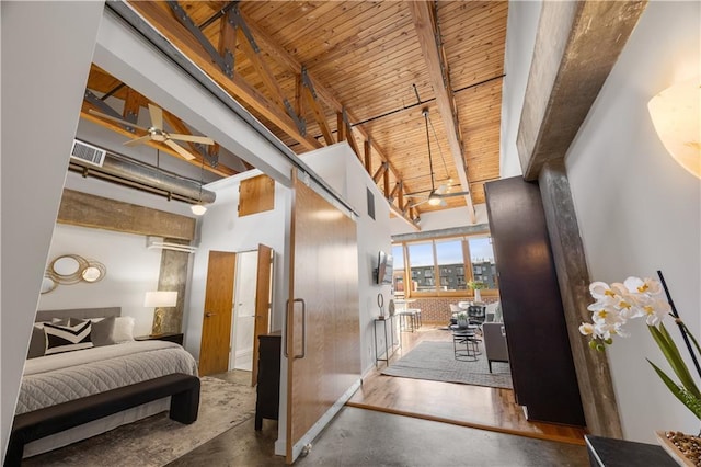 interior space with wood ceiling, concrete floors, beamed ceiling, and a high ceiling