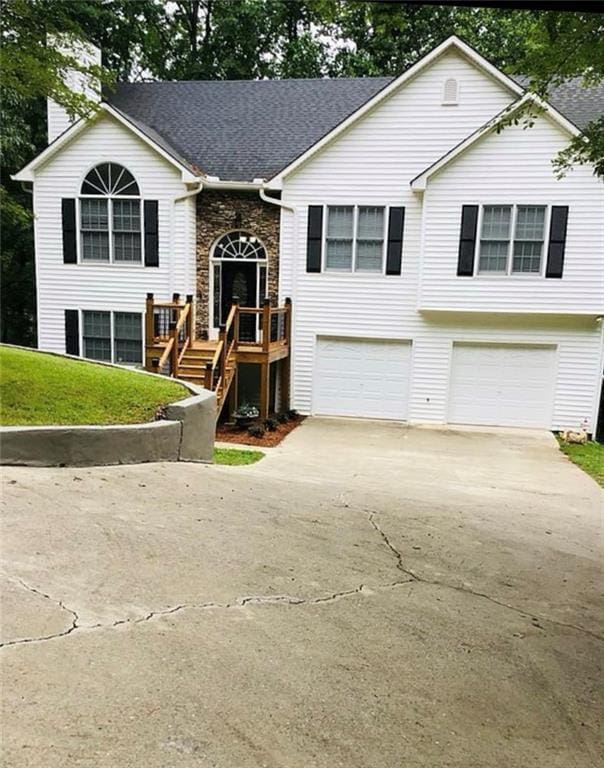 3535 Cameron Cir, Gainesville, GA 30506 - raised ranch featuring a garage, driveway, a chimney, and a front yard