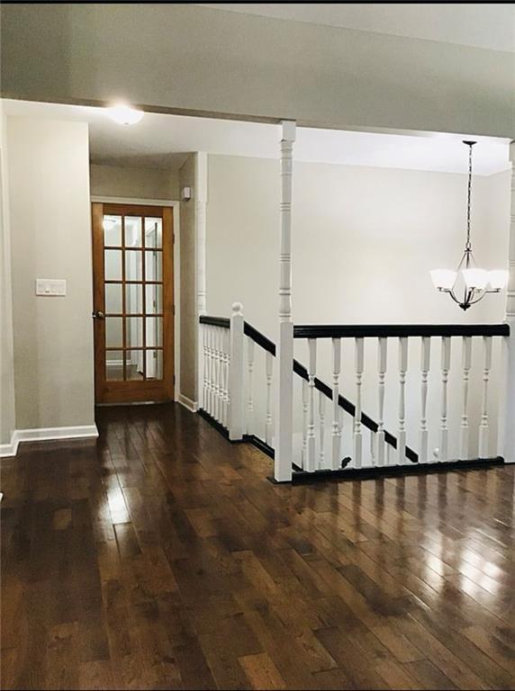 3535 Cameron Cir, Gainesville, GA 30506 - hallway featuring hardwood / wood-style floors, baseboards, an upstairs landing, and a chandelier