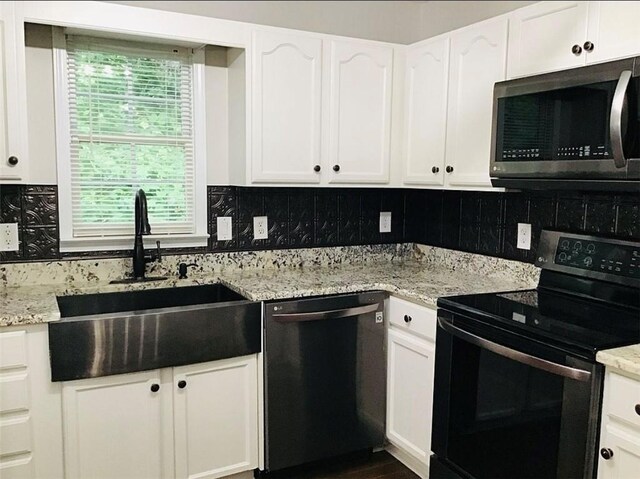 3535 Cameron Cir, Gainesville, GA 30506 - kitchen with stainless steel microwave, black range with electric stovetop, dishwashing machine, a sink, and decorative backsplash