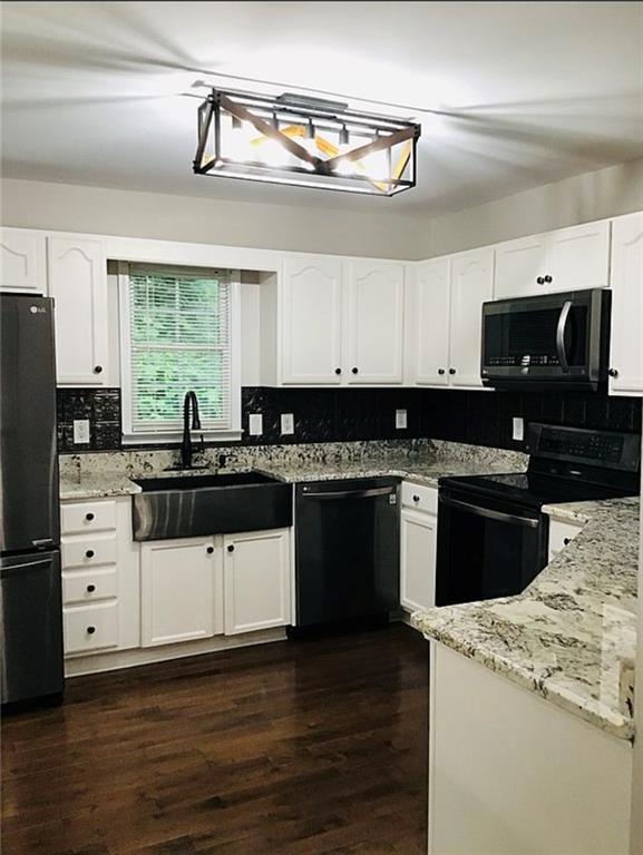 3535 Cameron Cir, Gainesville, GA 30506 - kitchen featuring black appliances, a sink, tasteful backsplash, white cabinets, and light stone countertops