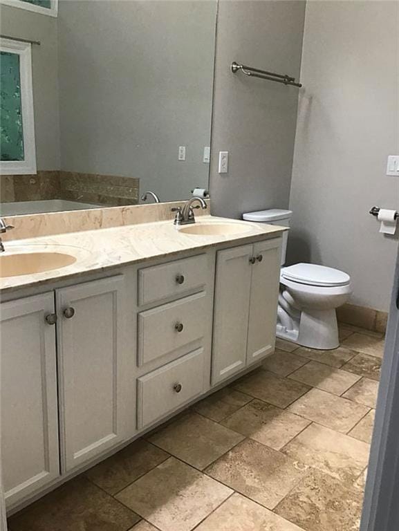 3535 Cameron Cir, Gainesville, GA 30506 - full bath with double vanity, toilet, stone finish floors, and a bath