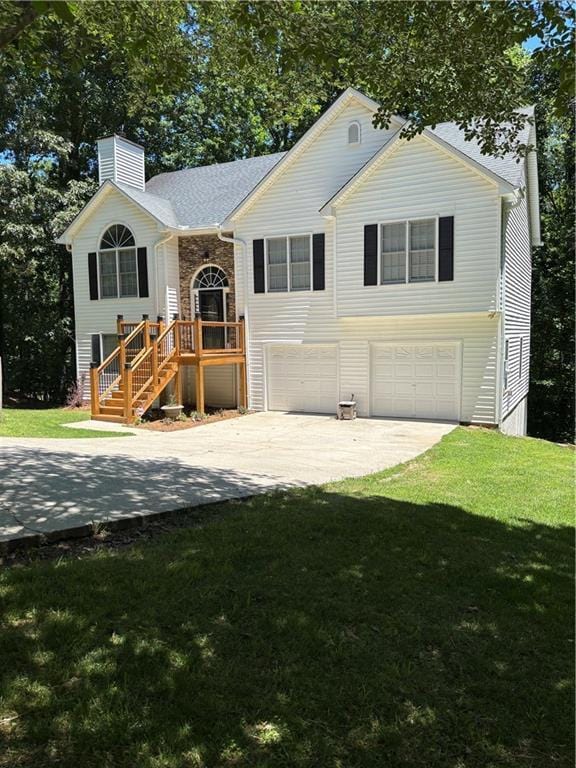 3535 Cameron Cir, Gainesville, GA 30506 - bi-level home featuring an attached garage, concrete driveway, a chimney, and a front lawn