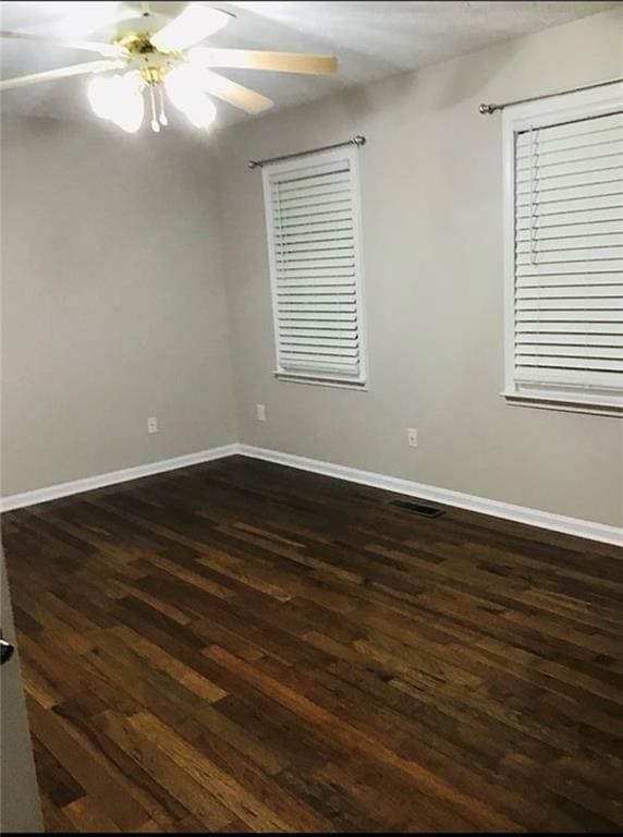 3535 Cameron Cir, Gainesville, GA 30506 - spare room with dark wood-style flooring, a ceiling fan, and baseboards