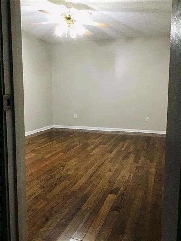 3535 Cameron Cir, Gainesville, GA 30506 - spare room featuring dark wood-style floors, baseboards, and a ceiling fan
