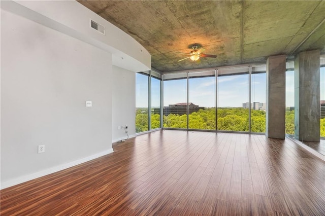 unfurnished sunroom with ceiling fan